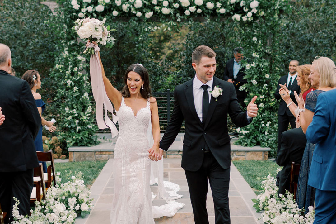 A bride and groom walking down the aisle together following their wedding ceremony at a Virginia winery & garden wedding venue called Fleetwood Farm Winery.