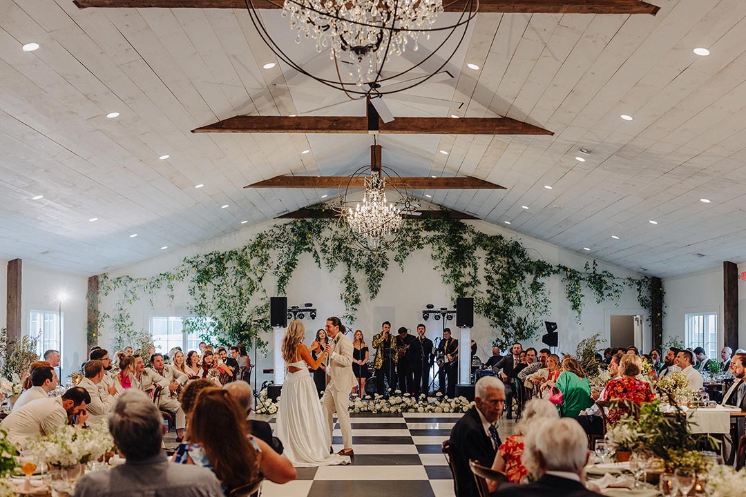 A bride and groom sharing their first dance at a wedding reception inside a winery wedding venue in Leesburg, Virginia.