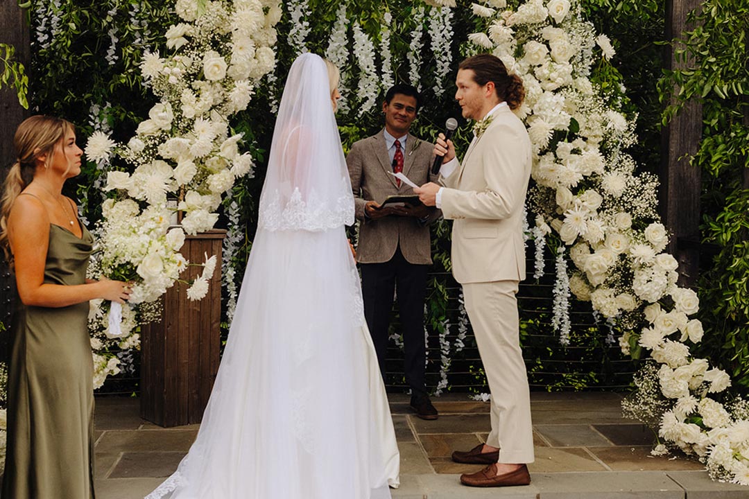 A groom delivering vows to a bride during a wedding ceremony in Fleetwood Farm Winery's garden wedding venue in Leesburg, Virginia.