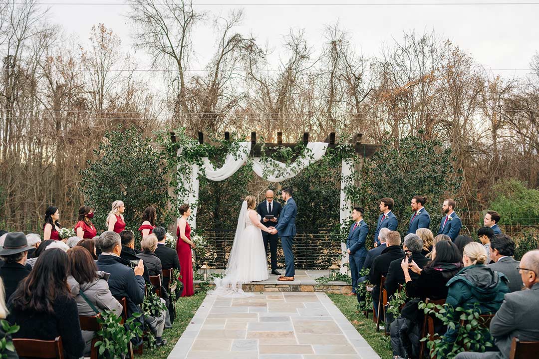 A wedding ceremony underway in Fleetwood Farm Winery's ceremony garden, which can serve as a winter wedding venue.