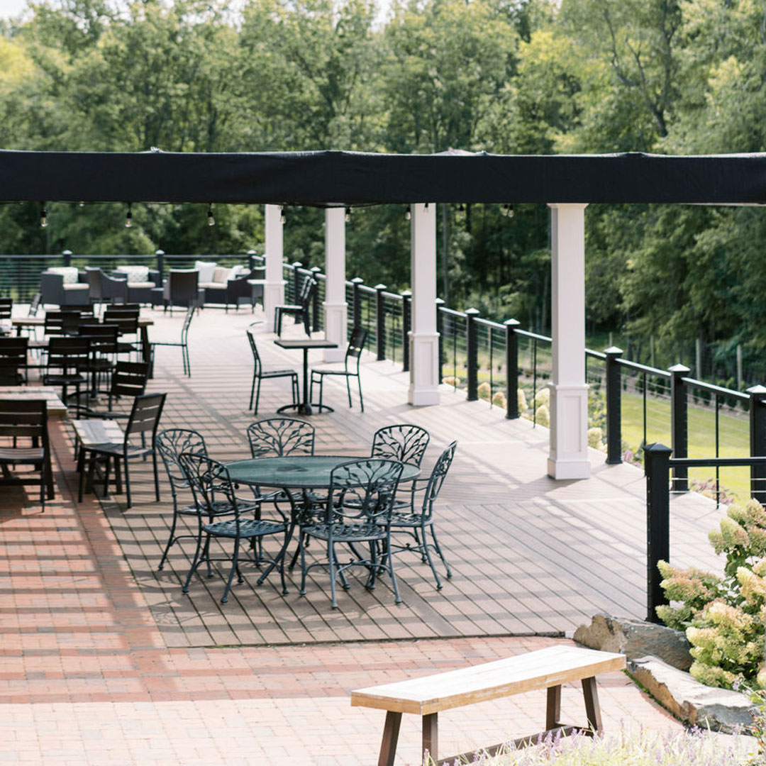 An elevated terrace area with tables at an outdoor event venue for 150 guests in Loudoun County, Virginia.