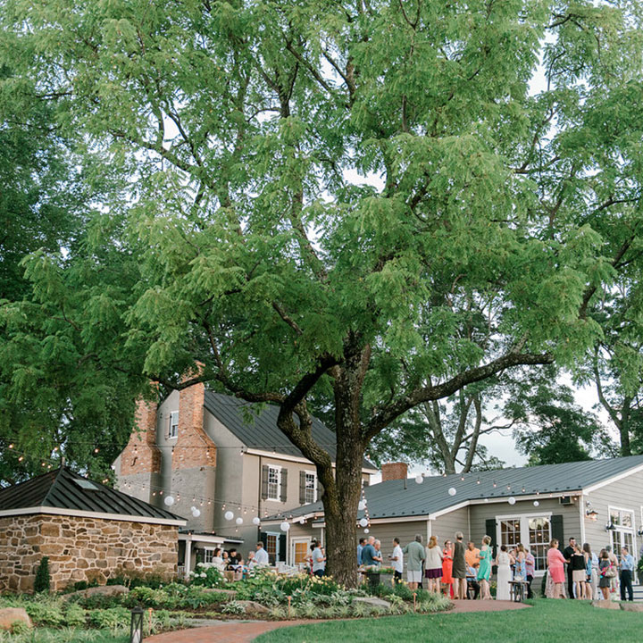 A large group of people socializing outside at a a private event venue with outdoor spaces in Leesburg, Virginia.