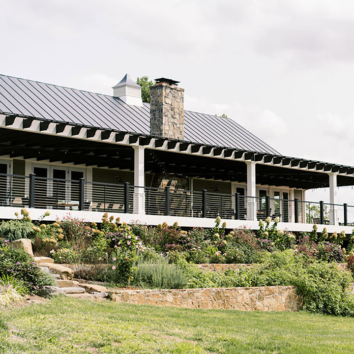 An elevated outdoor patio area positioned next to hydrangea plants at a Northern Virginia winery named Fleetwood Farm Winery in Leesburg, VA.