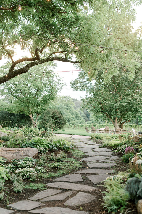 A stone walkway surrounded by nature at an outdoor winery in Leesburg, Virginia.