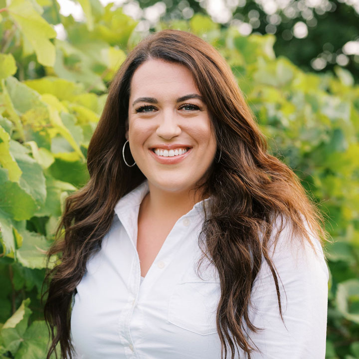 A closeup of a woman smiling who works as the Director Of Events at Fleetwood Farm Winery, a top Virginia winery.